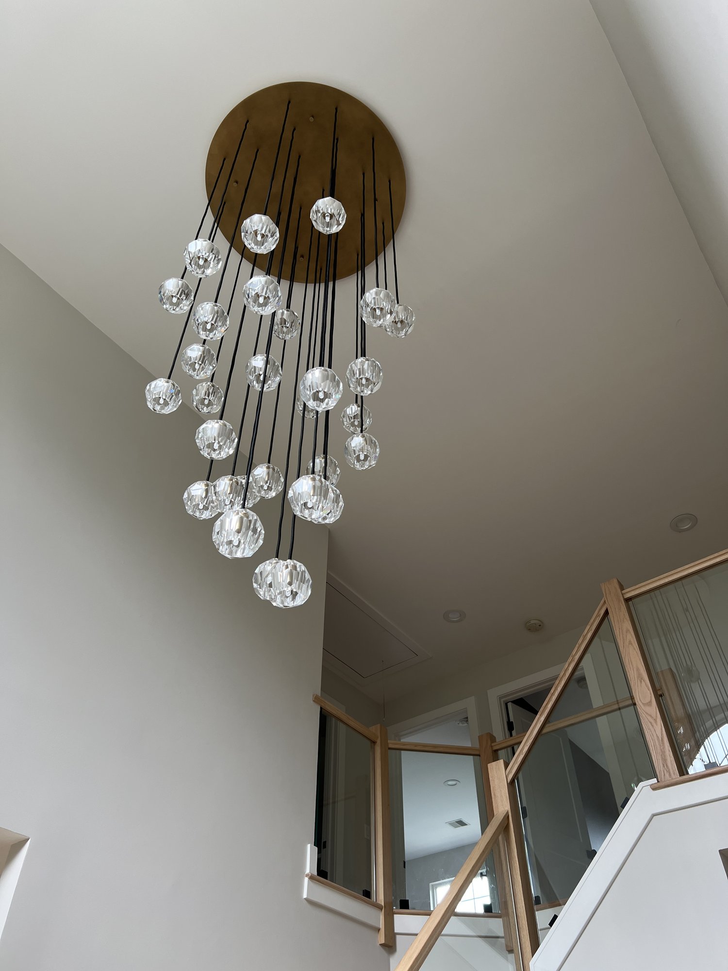 Foyer with cascading crystal chandelier and open staircase